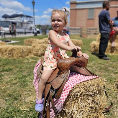 Kid Riding a Hay Bale at the Incredible Edibles Festival Campbellford